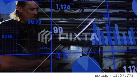 Studying man in dark coat reading data display at control room, with stylus charts, copy space 135573772