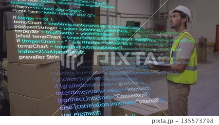 Scanning boxes on tablet in warehouse with code overlay, wearing safety vest, hard hat, copy space 135573798