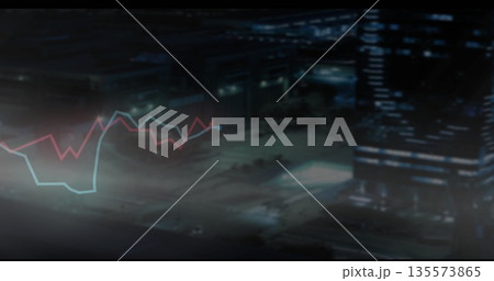 Displaying red and blue line graphs over blurry night road showing skyscraper and streetlights 135573865