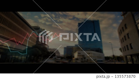 Showing glass skyscraper reflecting sunset on city avenue at dusk, with line graph overlay Showing glass skyscraper reflecting sunset on city avenue at dusk, with line graph overlay 135573870