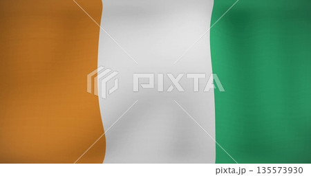 Displaying national flag fluttering against neutral plain backdrop, with vibrant tricolor design 135573930