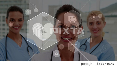 Standing female physician consulting team in hospital lobby, with stethoscopes and medical icons Standing female physician consulting team in hospital lobby, with stethoscopes and medical icons 135574023