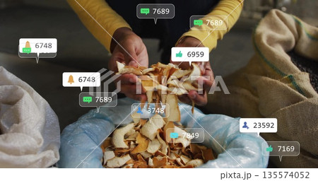 Woman in yellow shirt sorting peel shavings above blue bin in recycling area, with reaction icons Woman in yellow shirt sorting peel shavings above blue bin in recycling area, with reaction icons 135574052