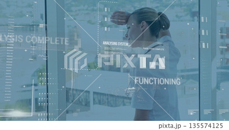 Shielding woman wearing white shirt analyzing charts at office window, digital interface panels Shielding woman wearing white shirt analyzing charts at office window, digital interface panels 135574125
