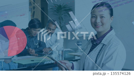 Medical team reviewing patient data in hospital meeting room, with tablet and charts, copy space 135574126