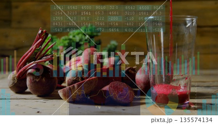 Displaying fresh and sliced beets on rustic table pouring juice into glass with digital overlay 135574134