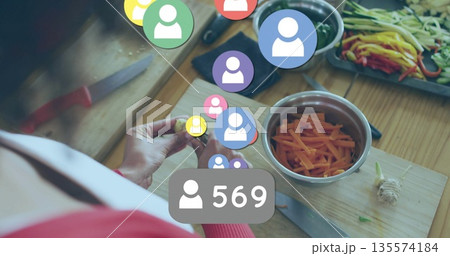 Slicing carrots with knife on kitchen cutting board, bell peppers, social media badge 569 Slicing carrots with knife on kitchen cutting board, bell peppers, social media badge 569 135574184