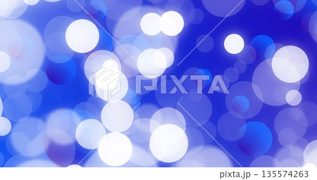 Floating white and blue blurred circular light spots forming pattern in abstract digital background 135574263