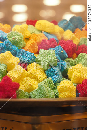 Colorful gummy candy assortment displayed in a glass container Colorful gummy candy assortment displayed in a glass container 135574380