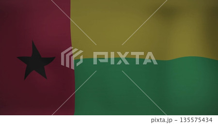 Waving fabric flag of Guinea-Bissau fluttering on fabric backdrop, showing gentle folds and shading 135575434