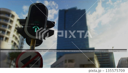 Displaying traffic light showing green up arrow, no-left-turn sign at city intersection, copy space 135575709