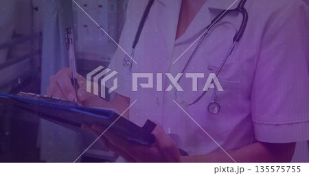 Writing nurse in scrubs using blue clipboard with pen in hospital corridor, with stethoscope Writing nurse in scrubs using blue clipboard with pen in hospital corridor, with stethoscope 135575755