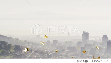 Featuring central skyline cluster shimmering through misty haze at hilltop, with gold star overlays 135575902