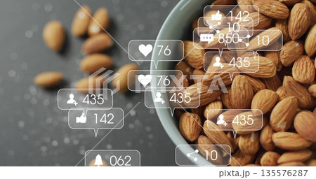 Displaying ceramic bowl holding almonds on dark countertop, with social media icons, copy space Displaying ceramic bowl holding almonds on dark countertop, with social media icons, copy space 135576287