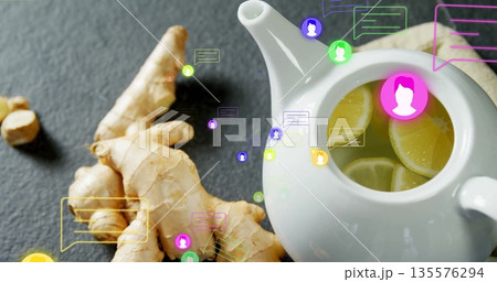 Displaying white ceramic teapot brewing lemon-ginger tea on tabletop with chat bubbles, copy space 135576294