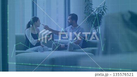 Coworkers in business attire discussing data metrics in lounge with tablet and line chart overlay Coworkers in business attire discussing data metrics in lounge with tablet and line chart overlay 135576521