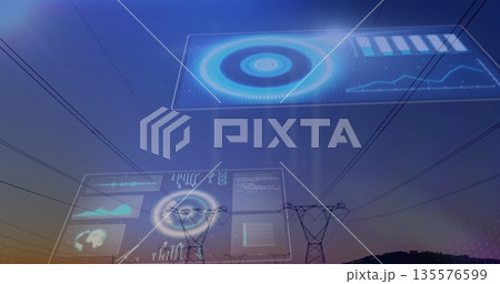 Showing towers carrying high-voltage lines in power corridor at dusk with holographic data panels 135576599