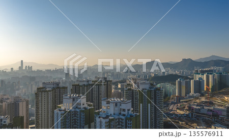 Jan 11 2026 Kwun Tong skyline glowing under vibrant evening sunset 135576911