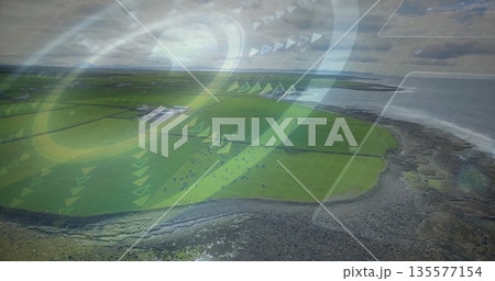 Showing aerial coastal farmland with divided pastures, grazing cattle, barns, coastline, overlays Showing aerial coastal farmland with divided pastures, grazing cattle, barns, coastline, overlays 135577154