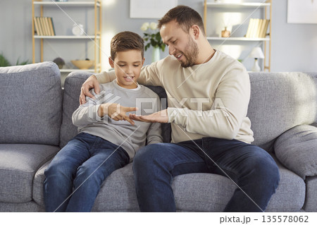 Young father and little child son playing rock paper scissors together at home Young father and little child son playing rock paper scissors together at home 135578062