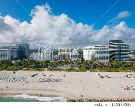 Aerial view of Miami city by the coast. Miami skyline with oceanfront skyscrapers. Scenic Miami panorama of Florida famous coastline. Drone shot of Miami above the shore. 135579585