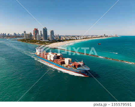 Cargo business. Container ship. Shipping logistics. Commercial shipping. Cargo ship in sea, drone view. Freight container loaded on cargo vessel. Aerial view cargo ship in sea 135579591