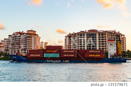 Miami, Florida, USA - April 07, 2025: Cargo Antillean Line ship services with container pass Fisher island, aerial. Freight container on cargo vessel. Cargo ship vessel. Miami port. Container ship Miami, Florida, USA - April 07, 2025: Cargo Antillean Line ship services with container pass Fisher island, aerial. Freight container on cargo vessel. Cargo ship vessel. Miami port. Container ship 135579671