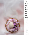 Easter Egg with Pink Flowers in Basket on Soft Pastel Background 135579804