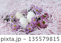 Easter Eggs with Pink Flowers in Decorative Nest, Close-Up 135579815