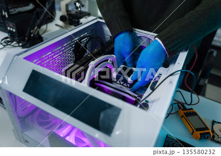 Hands repairing electronic devices. Electronic technician. Hands repairing electronic devices. Electronic technician. 135580232