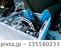 Hands repairing electronic devices. Electronic technician. 135580233