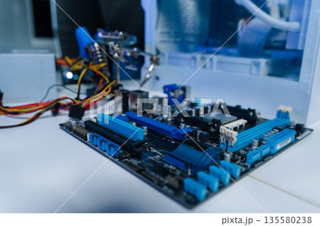 Hands repairing electronic devices. Electronic technician. 135580238