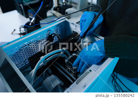 Hands repairing electronic devices. Electronic technician. Hands repairing electronic devices. Electronic technician. 135580242