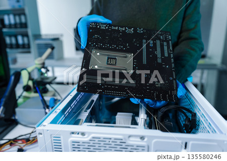Hands repairing electronic devices. Electronic technician. Hands repairing electronic devices. Electronic technician. 135580246
