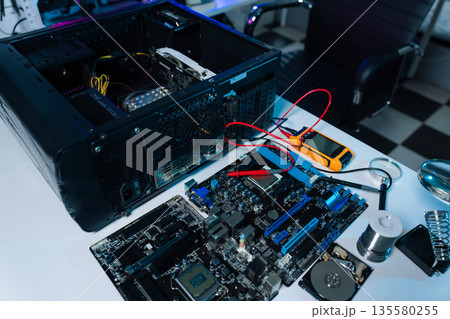 Hands repairing electronic devices. Electronic technician. 135580255