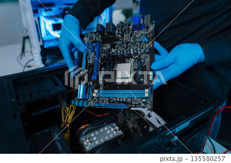 Hands repairing electronic devices. Electronic technician. 135580257