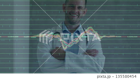 Standing doctor wearing lab coat in hospital corridor, with stethoscope, graph overlay 135580454