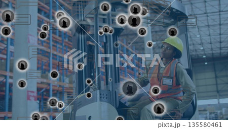 Operating forklift wearing safety gear with ID badge tracking icons over pallet racks in warehouse Operating forklift wearing safety gear with ID badge tracking icons over pallet racks in warehouse 135580461