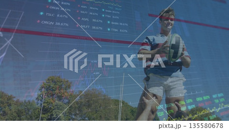Leaping rugby player in striped jersey catching ball on pitch, with stock charts, copy space Leaping rugby player in striped jersey catching ball on pitch, with stock charts, copy space 135580678