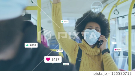 Talking woman wearing mask gripping handrail using phone on bus, social media icons, copy space 135580715