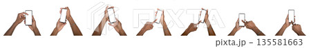 Hand holding smartphone with blank screen in mockup set. Black skin male using digital device for 135581663