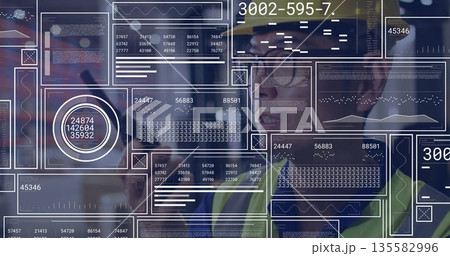 Interacting engineer wearing helmet, vest using data interface in factory control room, copy space Interacting engineer wearing helmet, vest using data interface in factory control room, copy space 135582996