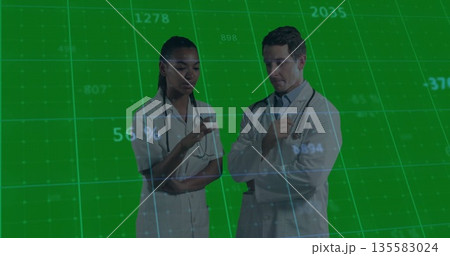 Two doctors in lab coats with stethoscopes gesturing and discussing data on green grid on screen Two doctors in lab coats with stethoscopes gesturing and discussing data on green grid on screen 135583024