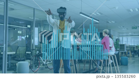 Gesturing man wearing white blazer and VR headset interacting in tech office, with controller 135583260