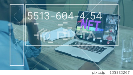 Adult male studying NFT graphic on laptop at conference table, with documents and UI overlays Adult male studying NFT graphic on laptop at conference table, with documents and UI overlays 135583267