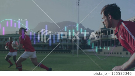 Leaning athlete wearing red rugby uniform on right field, with rugby ball, data overlay, copy space Leaning athlete wearing red rugby uniform on right field, with rugby ball, data overlay, copy space 135583346