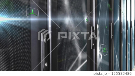 Showing perforated cabinet door displaying digital green propeller icon in server room, copy space 135583486