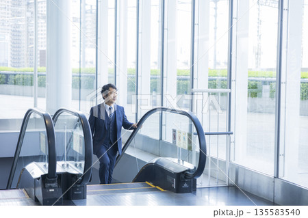 エスカレーターとビジネスマン 　 135583540