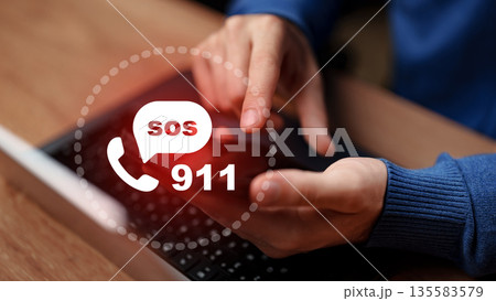 Sending an emergency message on a laptop to connect with help services quickly 135583579
