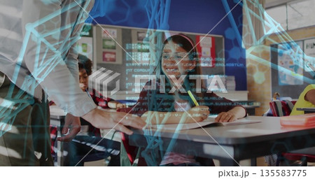 Smiling girl with headband writing on notebook in classroom near windows, holographic code overlay Smiling girl with headband writing on notebook in classroom near windows, holographic code overlay 135583775